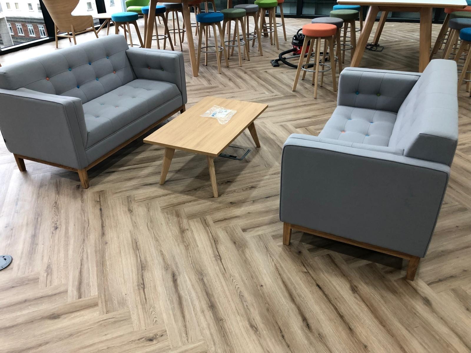 two grey sofas opposite each other with a rectangle table in between